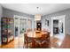 Cozy dining area featuring warm wood floors, a display cabinet, and natural light at 110 N Brown Ave, Orlando, FL 32801