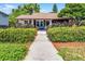 Charming bungalow featuring a well-manicured lawn, lush landscaping, and a welcoming front porch at 110 N Brown Ave, Orlando, FL 32801