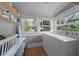 Bright laundry room with a washer, dryer, wood floors, and windows at 110 N Brown Ave, Orlando, FL 32801
