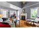 Cozy living room featuring hardwood floors, fireplace, and natural light at 110 N Brown Ave, Orlando, FL 32801