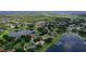 Stunning aerial view of a lakeside residential community with lush greenery and private docks on the water at 13524 Lake Luntz Dr, Winter Garden, FL 34787