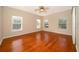 Bright bedroom boasts hardwood floors, neutral paint, and multiple windows for plenty of natural light at 13524 Lake Luntz Dr, Winter Garden, FL 34787