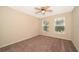 Neutral bedroom with carpet flooring, ceiling fan, and dual windows for natural light at 13524 Lake Luntz Dr, Winter Garden, FL 34787