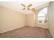 Bedroom with carpet flooring and fan, with a large arched window providing natural light at 13524 Lake Luntz Dr, Winter Garden, FL 34787