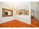 Bright dining area featuring hardwood floors, a chandelier, and a view of the living room at 13524 Lake Luntz Dr, Winter Garden, FL 34787