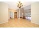 Dining room with tiled flooring, decorative chandelier, serving area, and access to a living room with french doors at 13524 Lake Luntz Dr, Winter Garden, FL 34787