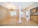 Charming dining room featuring tile floors, a modern chandelier, and a convenient wet bar at 13524 Lake Luntz Dr, Winter Garden, FL 34787