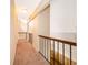 Well-lit upstairs hallway with carpet flooring, decorative railing and views of lower level at 13524 Lake Luntz Dr, Winter Garden, FL 34787