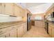 Spacious kitchen features granite countertops, wooden cabinets, tile flooring, and stainless steel appliances at 13524 Lake Luntz Dr, Winter Garden, FL 34787