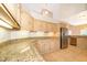 Kitchen boasts granite countertops, wooden cabinets, stainless steel appliances, and tile flooring at 13524 Lake Luntz Dr, Winter Garden, FL 34787
