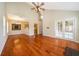 Large living room features hardwood floors, high ceilings, and access to a kitchen and outdoor area at 13524 Lake Luntz Dr, Winter Garden, FL 34787