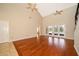 Spacious living room with vaulted ceilings, tile and hardwood floors, and french door access to the yard at 13524 Lake Luntz Dr, Winter Garden, FL 34787