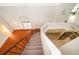 Open concept living room with wood floors and French doors, viewed from an upper-level stairwell at 13524 Lake Luntz Dr, Winter Garden, FL 34787