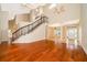 Spacious living room features hardwood floors, a staircase with iron railings, and soaring ceilings at 13524 Lake Luntz Dr, Winter Garden, FL 34787