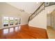 Bright living room boasts vaulted ceilings, hardwood floors, staircase, and french doors to the outdoor area at 13524 Lake Luntz Dr, Winter Garden, FL 34787