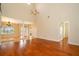 Open living room featuring hardwood floors, high ceilings, and a view of the front entrance at 13524 Lake Luntz Dr, Winter Garden, FL 34787