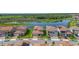An aerial view showcasing the community's serene pond and lush greenery, with terracotta-roofed houses at 13556 Abberwick Dr, Orlando, FL 32832