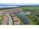 Beautiful aerial view of a neighborhood near a lake, showcasing homes, a pond, and natural Florida landscape at 13556 Abberwick Dr, Orlando, FL 32832