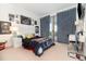 Bedroom with modern desk, sports-themed decor, and sliding glass doors at 13556 Abberwick Dr, Orlando, FL 32832