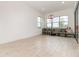 Versatile bonus room featuring tile floors, large windows, and a comfortable seating area at 13556 Abberwick Dr, Orlando, FL 32832