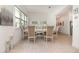 Elegant dining room with light wood floors, a stylish table setting, and ample natural light at 13556 Abberwick Dr, Orlando, FL 32832