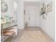 Bright foyer features a mirrored console table, neutral rug, and stylish decor, creating a welcoming entrance at 13556 Abberwick Dr, Orlando, FL 32832