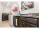 Laundry room with upper and lower cabinets and utility sink at 13556 Abberwick Dr, Orlando, FL 32832