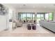 Bright living room features stylish seating, modern decor, light wood floors, and serene backyard views at 13556 Abberwick Dr, Orlando, FL 32832