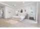 Bright main bedroom with tray ceiling, neutral carpet and decor, and sheer white window treatments at 13556 Abberwick Dr, Orlando, FL 32832