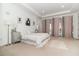 Elegant main bedroom featuring plush carpeting, a tray ceiling, chic decor, and access to a private balcony at 13556 Abberwick Dr, Orlando, FL 32832