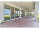 Outdoor patio area with brick pavers and sliding glass door access to interior at 13556 Abberwick Dr, Orlando, FL 32832
