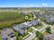 Property aerial view showcasing location close to green space, commercial areas, and surrounded by neighborhood homes at 14124 Eliot Ave, Orlando, FL 32827