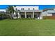 Expansive backyard featuring a well-maintained lawn and covered patio with an outdoor kitchen at 14124 Eliot Ave, Orlando, FL 32827