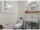 Chic half bathroom features modern fixtures, a vessel sink, and a round mirror at 14124 Eliot Ave, Orlando, FL 32827