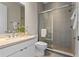 Modern bathroom featuring a glass-enclosed shower, single sink, and neutral tile at 14124 Eliot Ave, Orlando, FL 32827