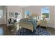 Sunlit bedroom with a queen bed, complemented by blue accents and a view of the sky at 14124 Eliot Ave, Orlando, FL 32827