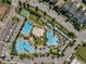 Aerial view of a community pool area with multiple pools, lounging areas, and well-maintained landscaping at 14124 Eliot Ave, Orlando, FL 32827