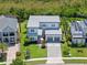 Aerial view of a modern two-story home featuring a well-manicured lawn and two car garage at 14124 Eliot Ave, Orlando, FL 32827