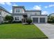 Modern two-story home with well-manicured lawn and three-car garage at 14124 Eliot Ave, Orlando, FL 32827