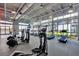 Well-equipped fitness center with modern cardio machines and floor-to-ceiling windows offering serene views at 14124 Eliot Ave, Orlando, FL 32827