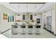 Bright, modern kitchen features a waterfall island with seating, stainless steel appliances, and stylish pendant lighting at 14124 Eliot Ave, Orlando, FL 32827