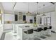 Stylish kitchen showcases an expansive marble island with seating, modern cabinetry, and stainless steel appliances at 14124 Eliot Ave, Orlando, FL 32827