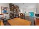 Stylish living room featuring a full wall of built-in bookshelves and comfortable seating area on hardwood floors at 14124 Eliot Ave, Orlando, FL 32827