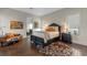 Comfortable primary bedroom with hardwood floors and ensuite bathroom access at 14124 Eliot Ave, Orlando, FL 32827