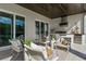 Covered outdoor space with a built-in kitchen, grill, and comfortable seating area at 14124 Eliot Ave, Orlando, FL 32827