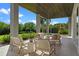 Inviting covered patio with comfortable seating, perfect for relaxing and enjoying the lush backyard views at 14124 Eliot Ave, Orlando, FL 32827