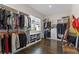 Spacious walk-in closet with custom shelving, hanging rods, and ample storage for clothing and accessories at 14124 Eliot Ave, Orlando, FL 32827
