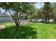 Green backyard with a white pergola and view of the water at 14193 Gold Bridge Dr, Orlando, FL 32824