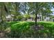 Lush green backyard featuring a pergola and view of the home's exterior at 14193 Gold Bridge Dr, Orlando, FL 32824