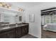 Bright bathroom with double vanity, granite counters, and access to the main bedroom at 14193 Gold Bridge Dr, Orlando, FL 32824